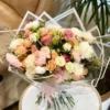 A vibrant bouquet of assorted flowers elegantly arranged inside a clear plastic bag, showcasing their natural beauty.