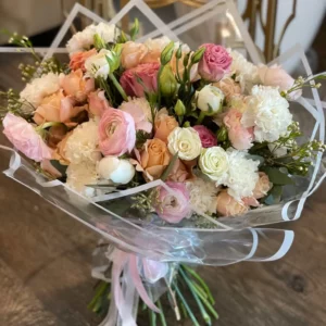 A vibrant bouquet of assorted flowers elegantly arranged inside a clear plastic bag, showcasing their natural beauty.