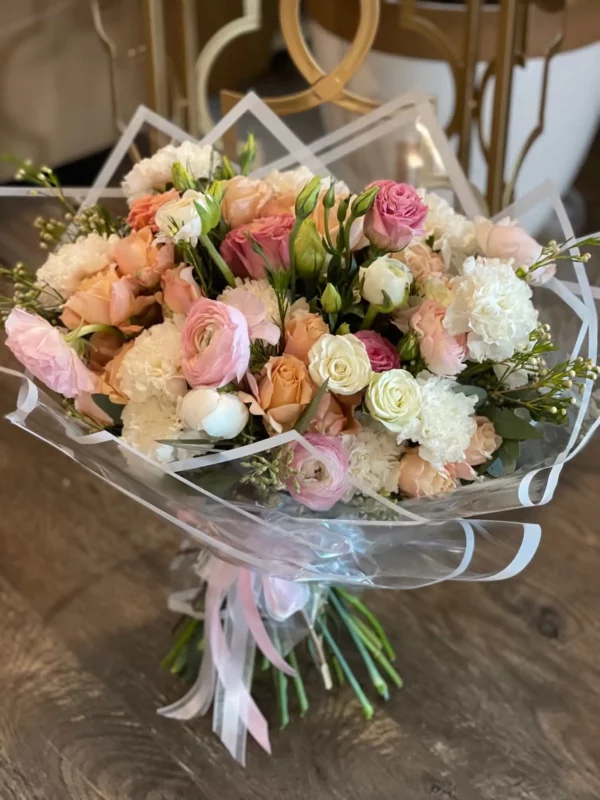 A vibrant bouquet of assorted flowers elegantly arranged inside a clear plastic bag, showcasing their natural beauty.