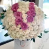 A beautiful arrangement of white and pink roses elegantly displayed in a pristine white box.