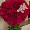 A heart-shaped arrangement featuring vibrant red roses and delicate orchids, symbolizing love and beauty.