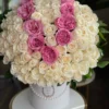 A beautiful arrangement of white and pink roses elegantly displayed in a pristine white box.