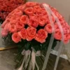 A large bouquet of pink roses elegantly arranged on a table, showcasing their vibrant color and lush petals.