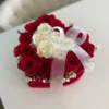 A heart-shaped arrangement featuring vibrant red and elegant white roses, symbolizing love and purity.