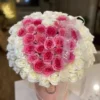 A heart-shaped arrangement of pink and white flowers, beautifully crafted to create a romantic and elegant display.