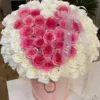 A heart-shaped arrangement of pink and white flowers, beautifully crafted to create a romantic and elegant display.