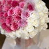 A heart-shaped arrangement of pink and white flowers, beautifully crafted to create a romantic and elegant display.