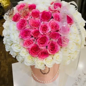 A heart-shaped arrangement of pink and white flowers, beautifully crafted to create a romantic and elegant display.