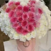 A heart-shaped arrangement of pink and white flowers, beautifully crafted to create a romantic and elegant display.