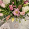 A white box filled with delicate pink and white flowers, creating a charming and elegant floral arrangement.