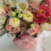 A vibrant bouquet of flowers arranged beautifully in a stylish pink bag, showcasing a delightful mix of colors.