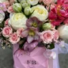 A vibrant bouquet of flowers arranged beautifully in a stylish pink bag, showcasing a delightful mix of colors.