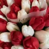 A vibrant bouquet featuring red and white tulips arranged elegantly in a decorative vase.