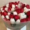 A vibrant bouquet featuring red and white tulips arranged elegantly in a decorative vase.