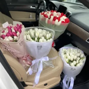 A vibrant bunch of flowers arranged in a car seat, adding a touch of color and beauty to the vehicle's interior.