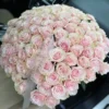 A large bouquet of pink roses elegantly arranged in the back seat of a car, adding a touch of beauty and romance.