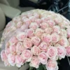 A large bouquet of pink roses elegantly arranged in the back seat of a car, adding a touch of beauty and romance.