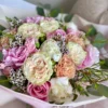 A lovely bouquet featuring pink and white flowers placed on a table, creating a serene and inviting atmosphere.