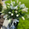 A bouquet of elegant white tulips arranged in a sleek black vase, showcasing a striking contrast of colors.