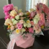 A vibrant bouquet of flowers arranged beautifully in a stylish pink bag, showcasing a delightful mix of colors.