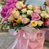 A vibrant bouquet of flowers arranged beautifully in a stylish pink bag, showcasing a delightful mix of colors.