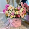 A vibrant bouquet of flowers arranged beautifully in a stylish pink bag, showcasing a delightful mix of colors.