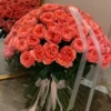 A large bouquet of pink roses elegantly arranged on a table, showcasing their vibrant color and lush petals.