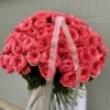 A large bouquet of pink roses elegantly arranged on a table, showcasing their vibrant color and lush petals.