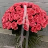 A large bouquet of pink roses elegantly arranged on a table, showcasing their vibrant color and lush petals.